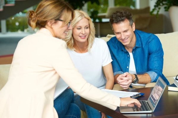 Couple consulting with real estate agent in their home